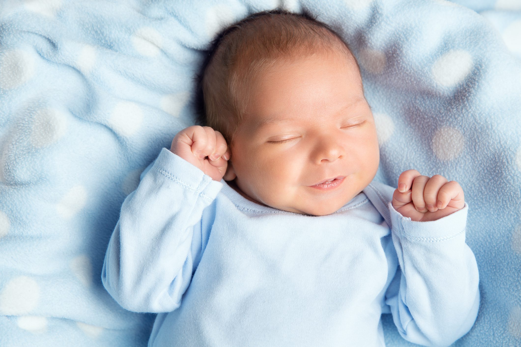 Newborn peacefully resting on soft blanket