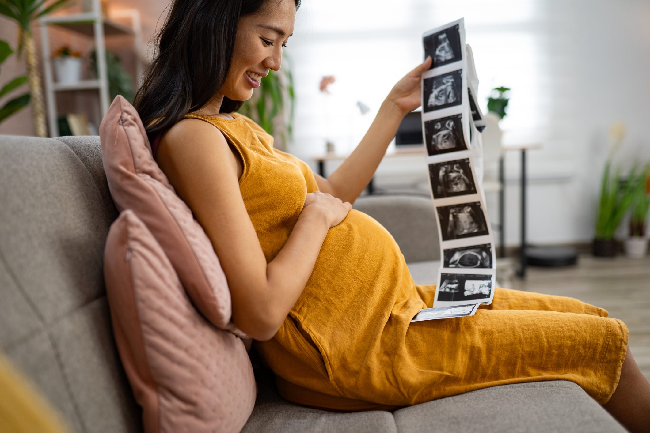 Woman smiling at pregnancy ultrasound pictures