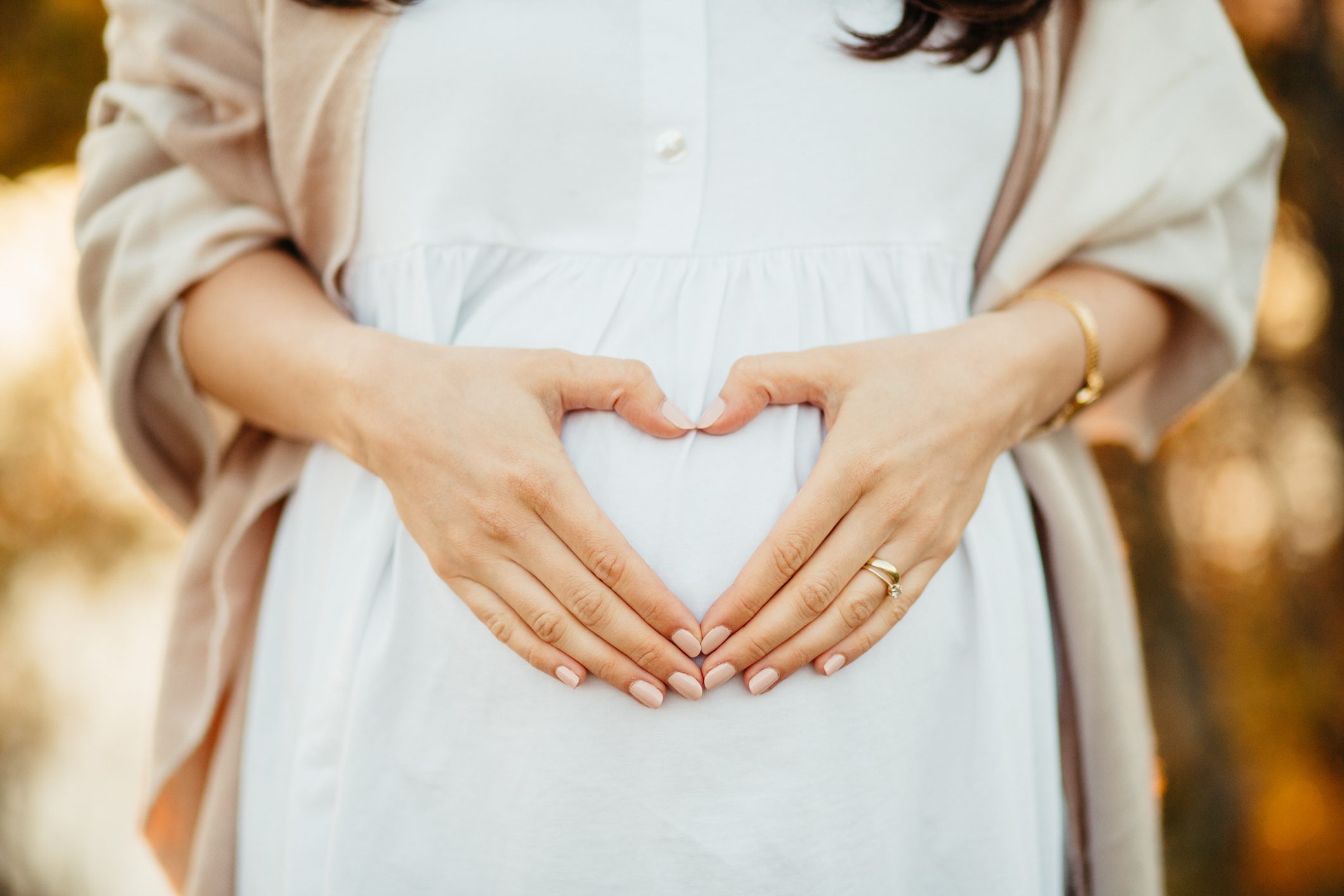 Woman's hands on pregnant belly