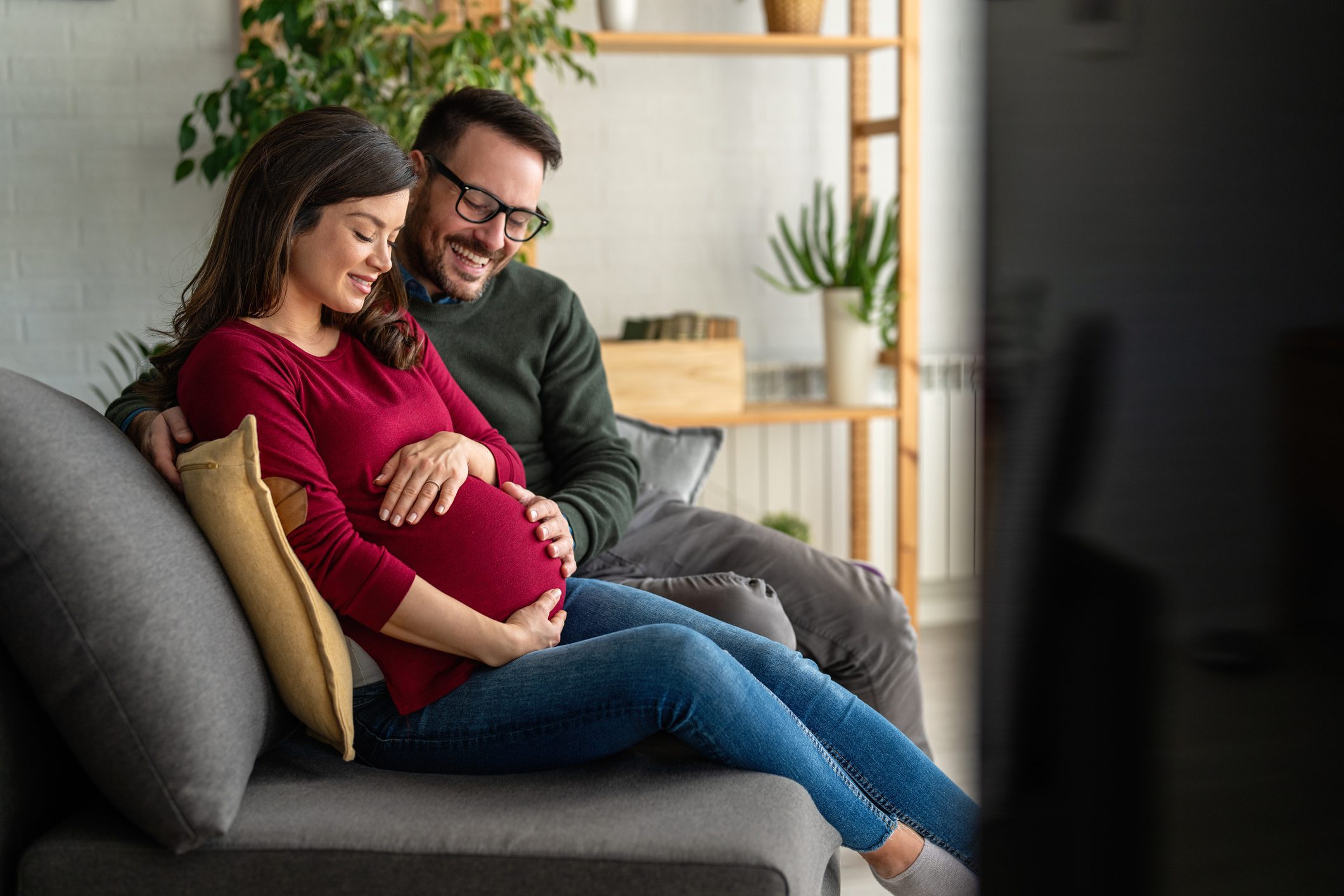 Couple smiling at pregnant woman's belly