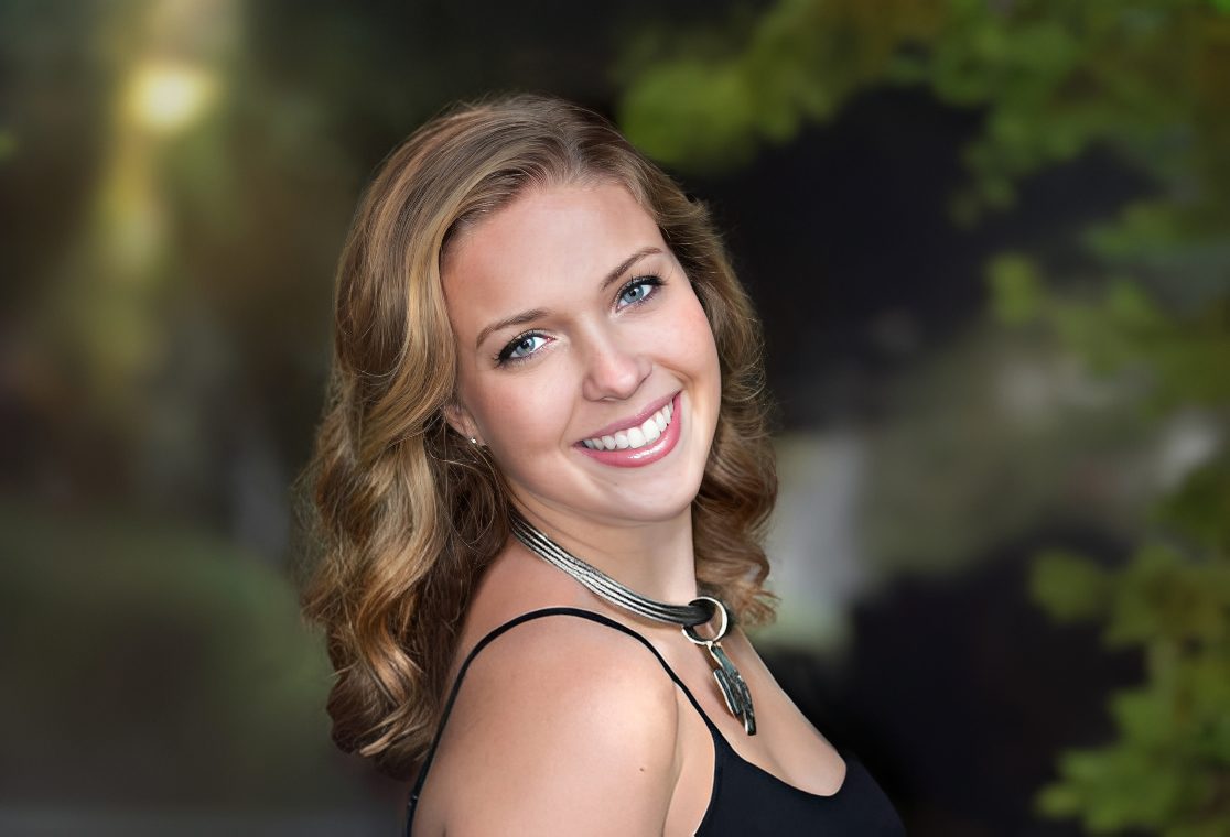 Cheerful woman posing in garden setting