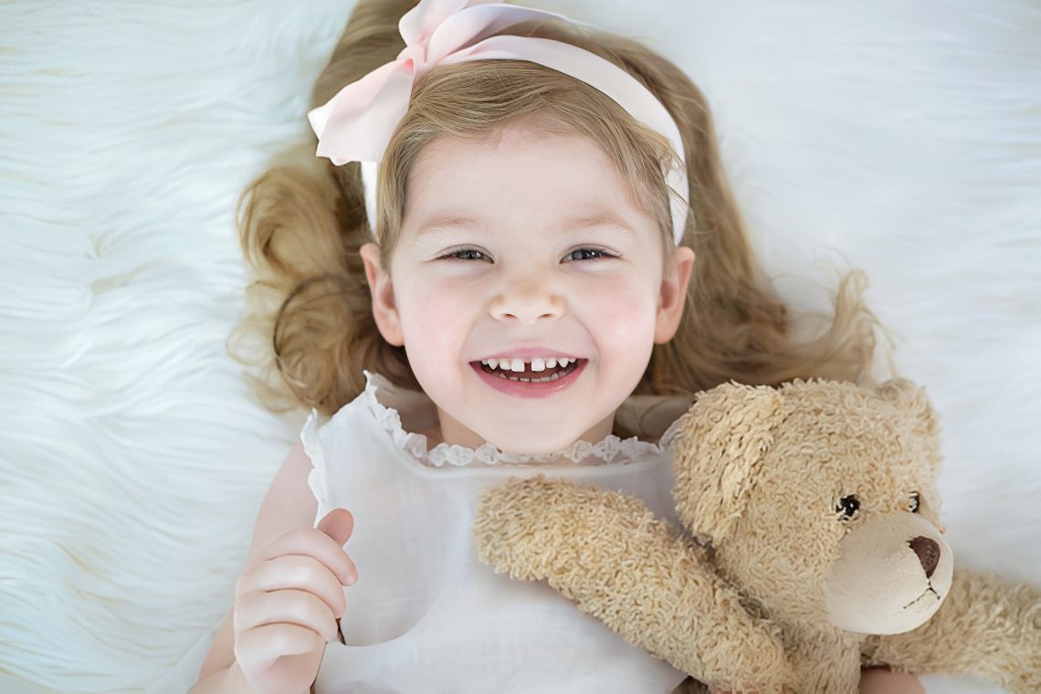 Smiling child with teddy bear