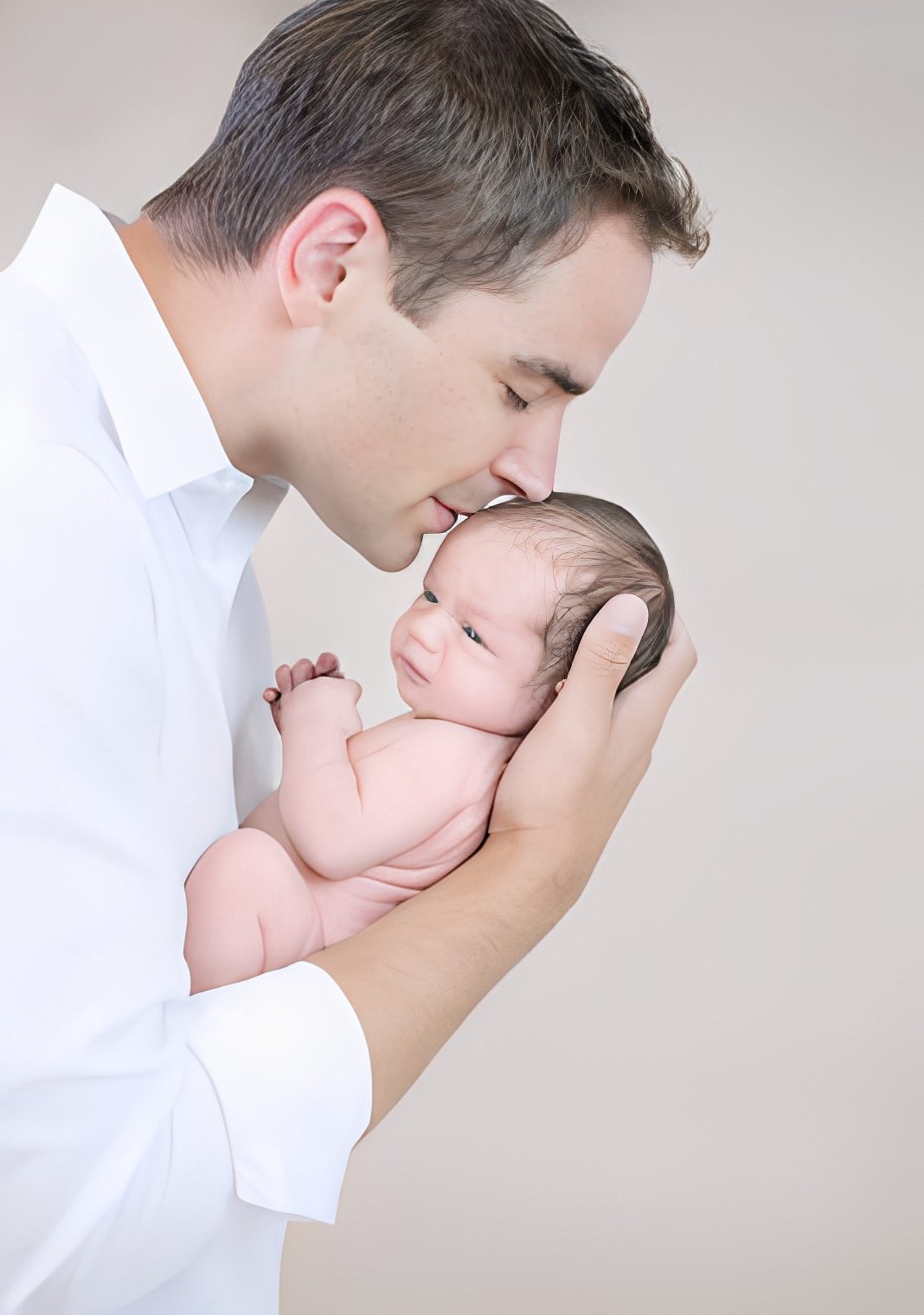 Man holding and kissing infant