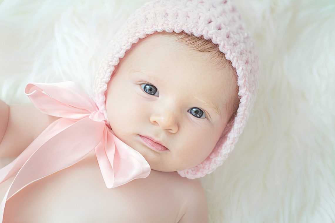 Adorable baby on soft white blanket