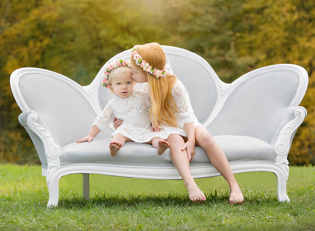 Mother and daughter on white couch