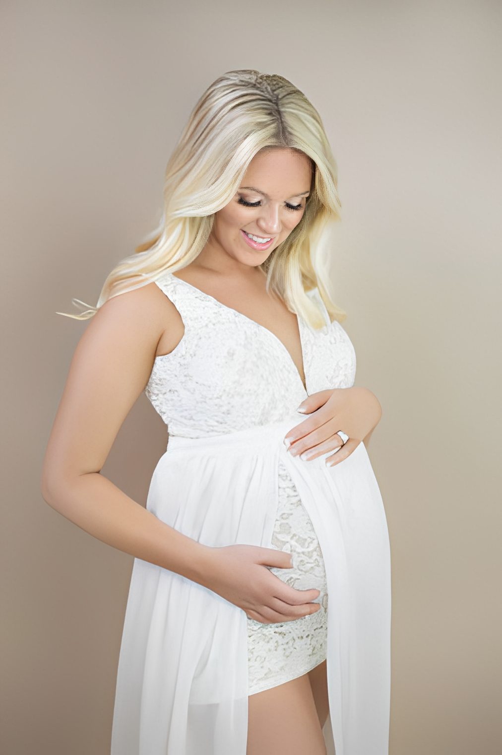 Woman cradling her baby bump lovingly
