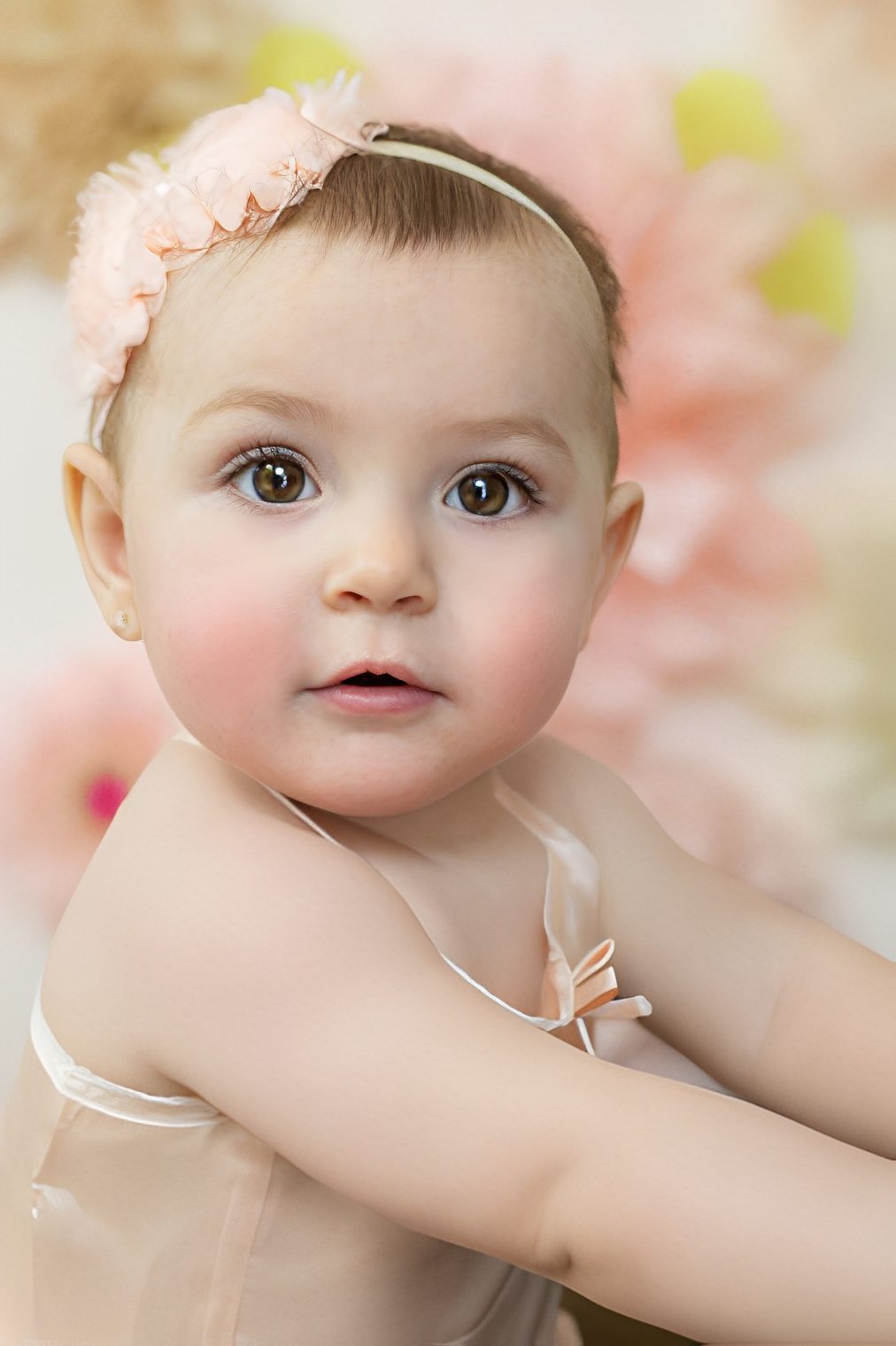 Adorable baby portrait with floral backdrop